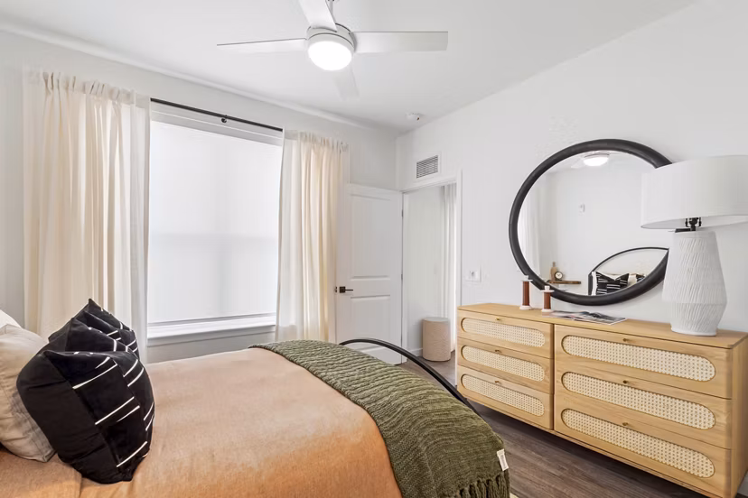 Cozy bedroom with modern decor at Soluna Apartments, showcasing luxury living spaces in a Greystar community