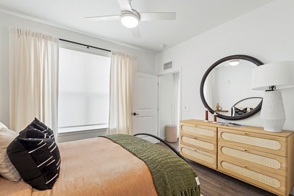 Cozy bedroom with modern decor at Soluna Apartments, showcasing luxury living spaces in a Greystar community