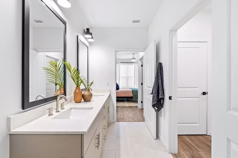Bathroom featuring elegant fixtures and double vanity at Soluna Apartments, a Greystar luxury property