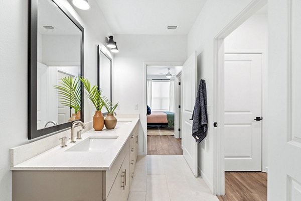 Bathroom featuring elegant fixtures and double vanity at Soluna Apartments, a Greystar luxury property