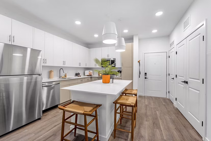 Modern kitchen with granite countertops and stainless steel appliances at Soluna Apartments