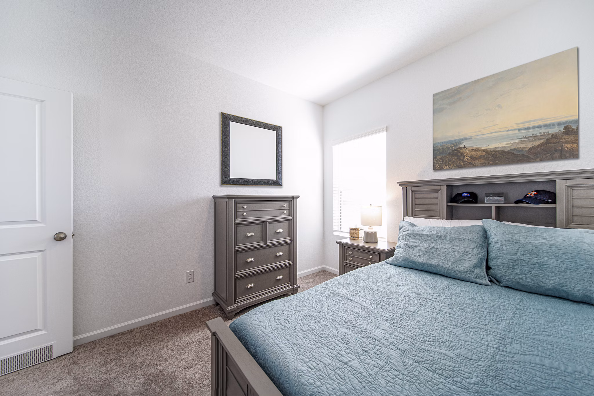 Cozy bedroom with elegant decor at Balcara at Meridiana Homes, featuring plush bedding and modern design elements