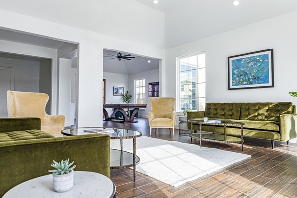 Clubhouse featuring modern design and relaxing seating at Balcara at Meridiana Homes apartments