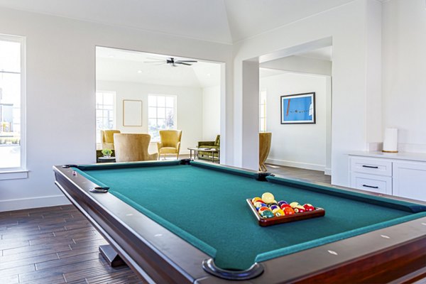 Clubhouse game room featuring billiards and cozy seating at Balcara at Meridiana Homes luxury apartments