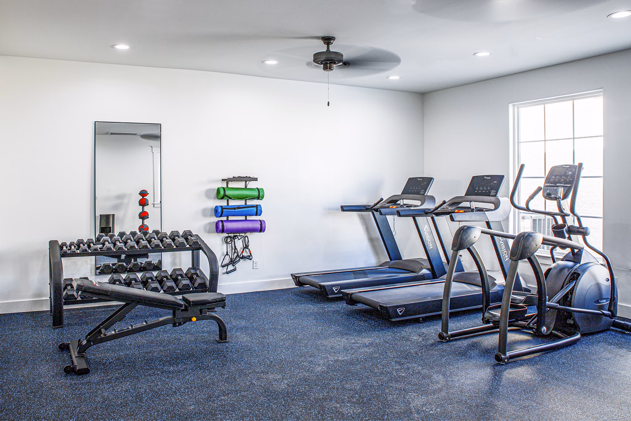 Modern fitness center featuring state-of-the-art equipment at Balcara at Meridiana Homes