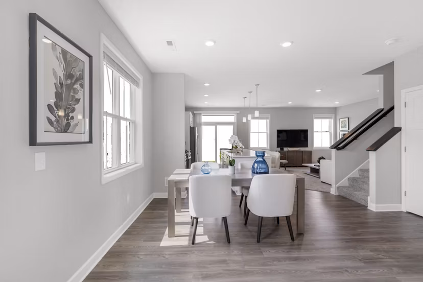 Dining area with elegant decor in Bentley Village Apartments, featuring a modern table setting and stylish lighting accents