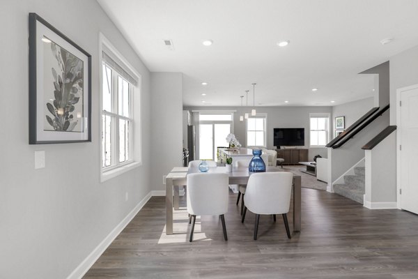 Dining area with elegant decor in Bentley Village Apartments, featuring a modern table setting and stylish lighting accents