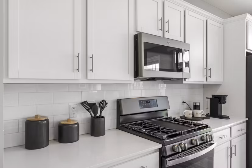 Modern kitchen with stainless steel appliances at Bentley Village Apartments