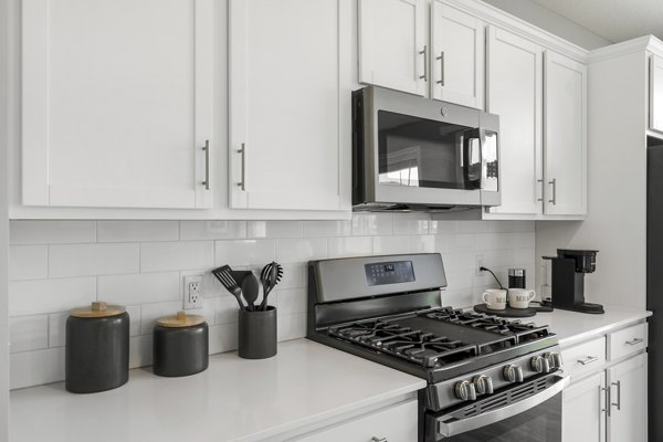 Modern kitchen with stainless steel appliances at Bentley Village Apartments