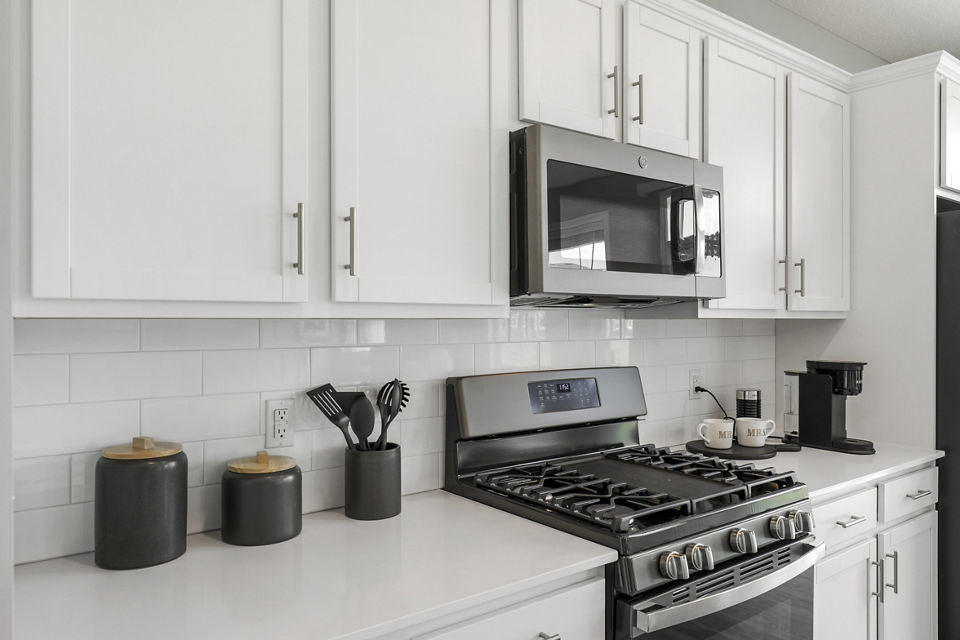 Modern kitchen with stainless steel appliances at Bentley Village Apartments