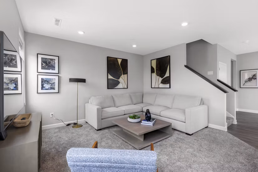 Spacious living room with elegant furnishings in Bentley Village Apartments
