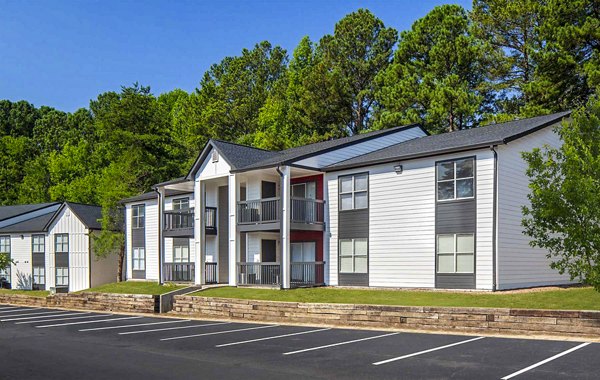 The Oakley Apartments: Stylish mid-rise building surrounded by lush greenery in vibrant city setting