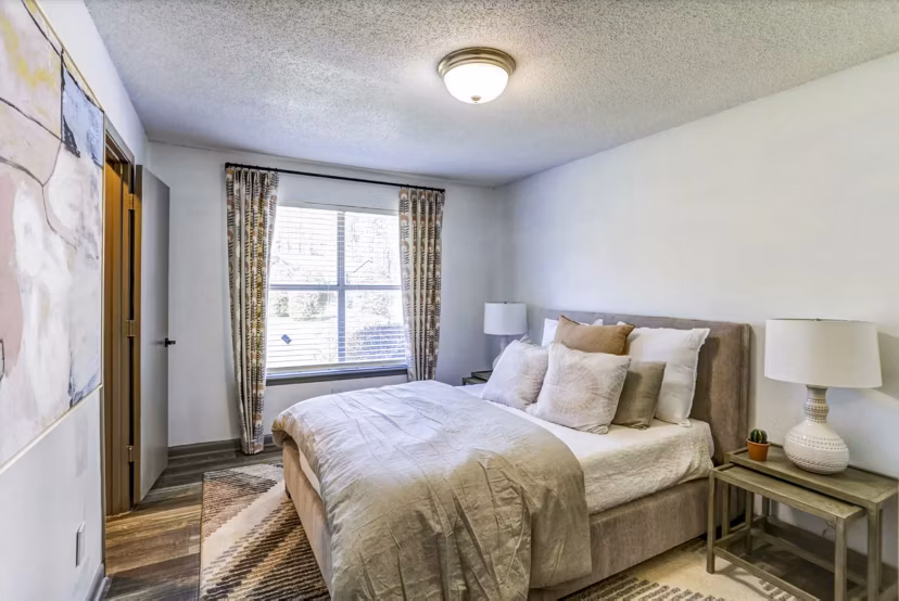 Contemporary bedroom featuring elegant finishes at The Oakley Apartments