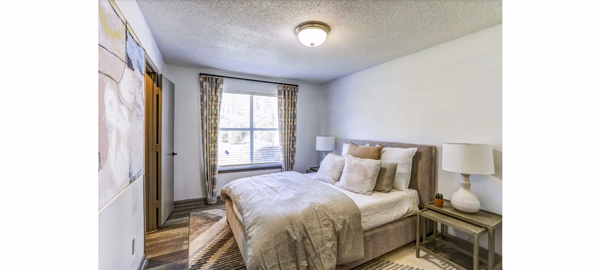 Contemporary bedroom featuring elegant finishes at The Oakley Apartments