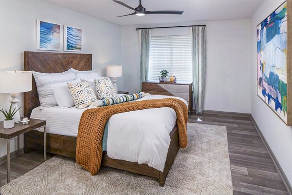 Cozy bedroom featuring modern furnishings at The Oakley Apartments, luxury living by Greystar