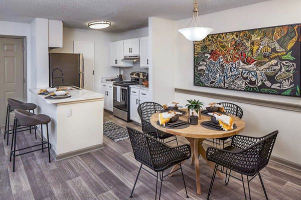 Dining room with modern furnishings at The Oakley Apartments, featuring elegant seating and contemporary design for a luxurious living experience