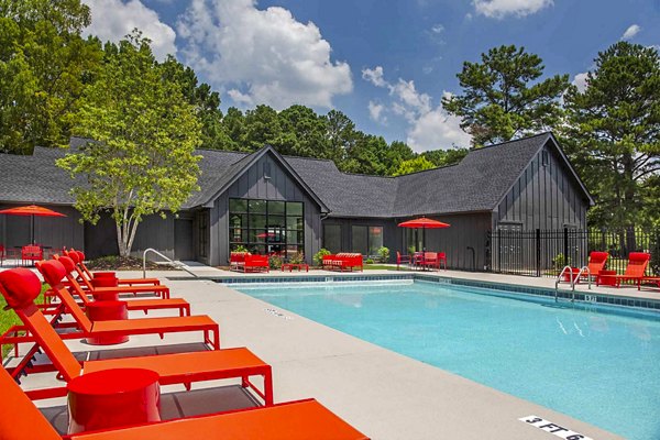 Modern pool with sun loungers at The Oakley Apartments, offering luxury living and relaxation amenities