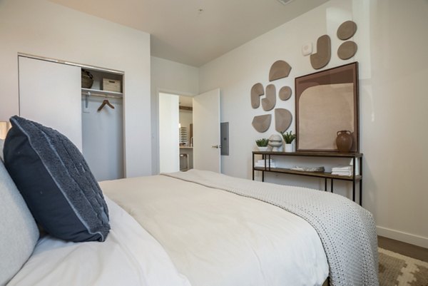 Cozy bedroom with modern furnishings at Encanto at Mesa Del Sol Apartments