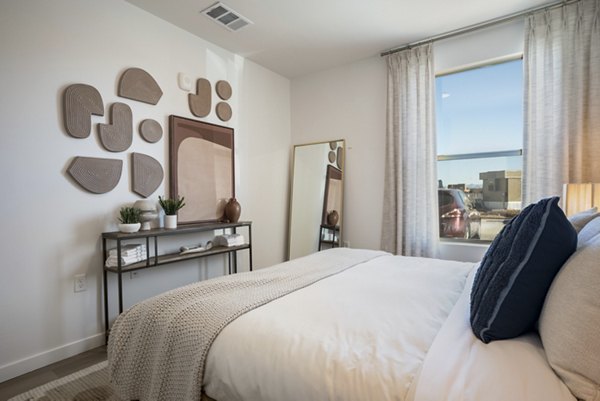 Modern bedroom with mountain views at Encanto at Mesa Del Sol luxury apartments