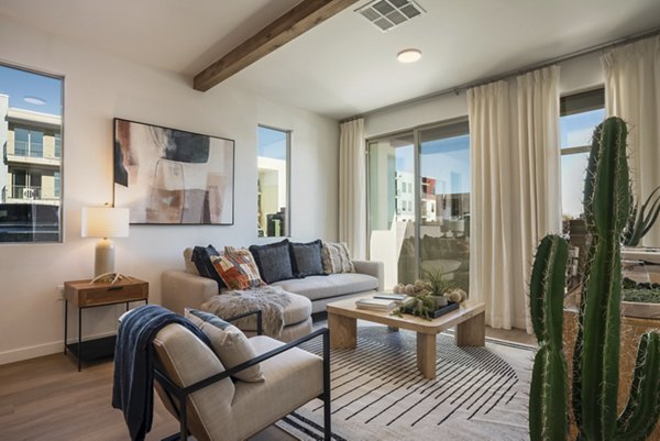 Modern living room with mountain views at Encanto at Mesa Del Sol Apartments