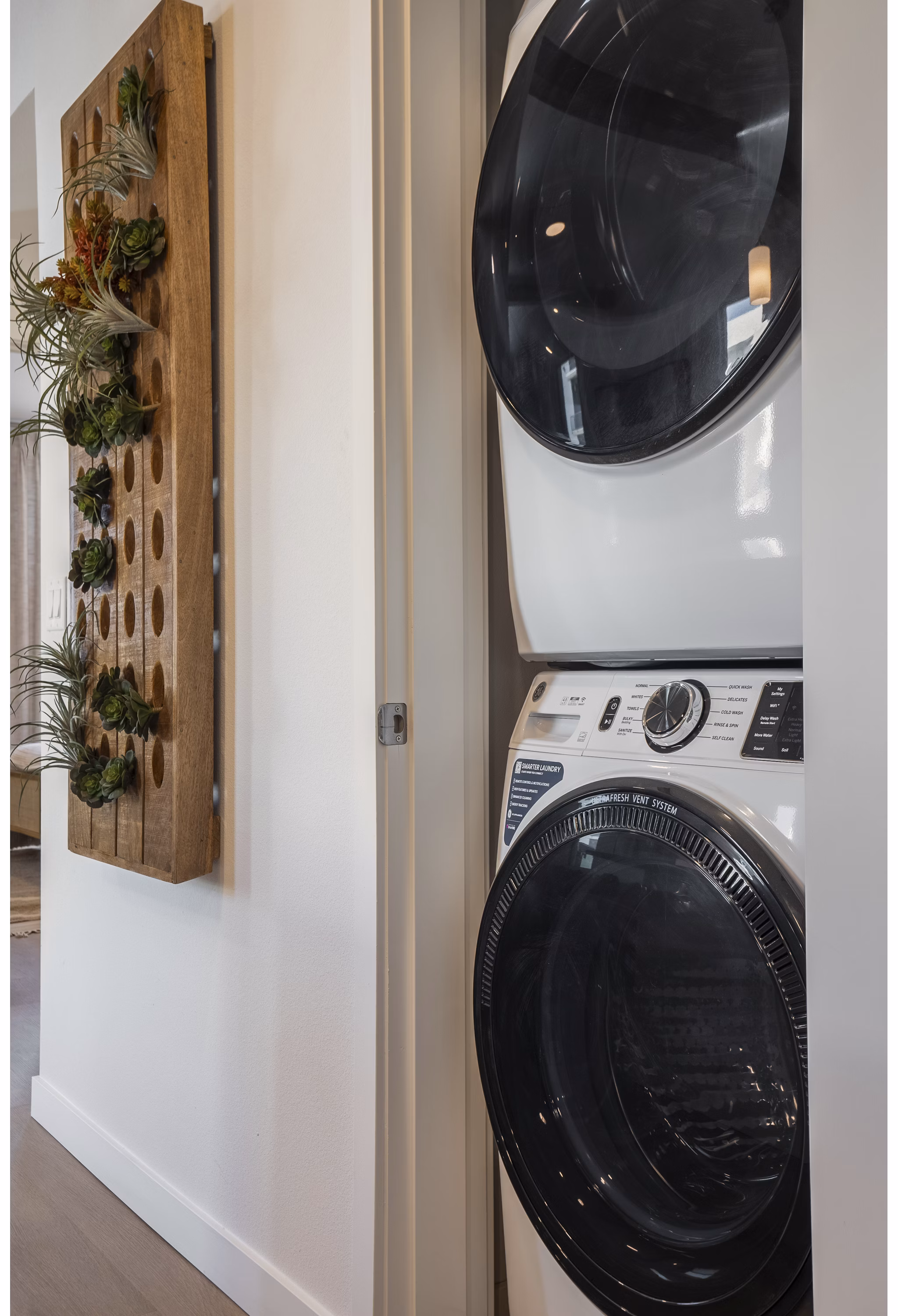 Laundry room with energy-efficient washer and dryer at Encanto at Mesa Del Sol Apartments