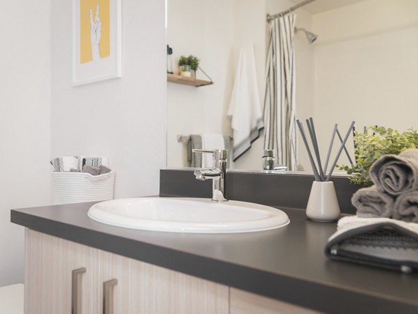 Modern bathroom featuring sleek design and marble countertops at The Parsonage Apartments