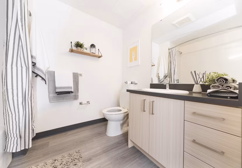 Luxurious bathroom with marble countertops and soaking tub at The Parsonage Apartments