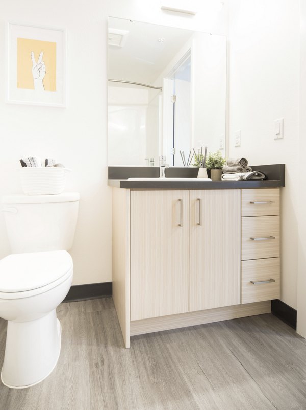 Luxurious bathroom with marble countertops and soaking tub at The Parsonage Apartments