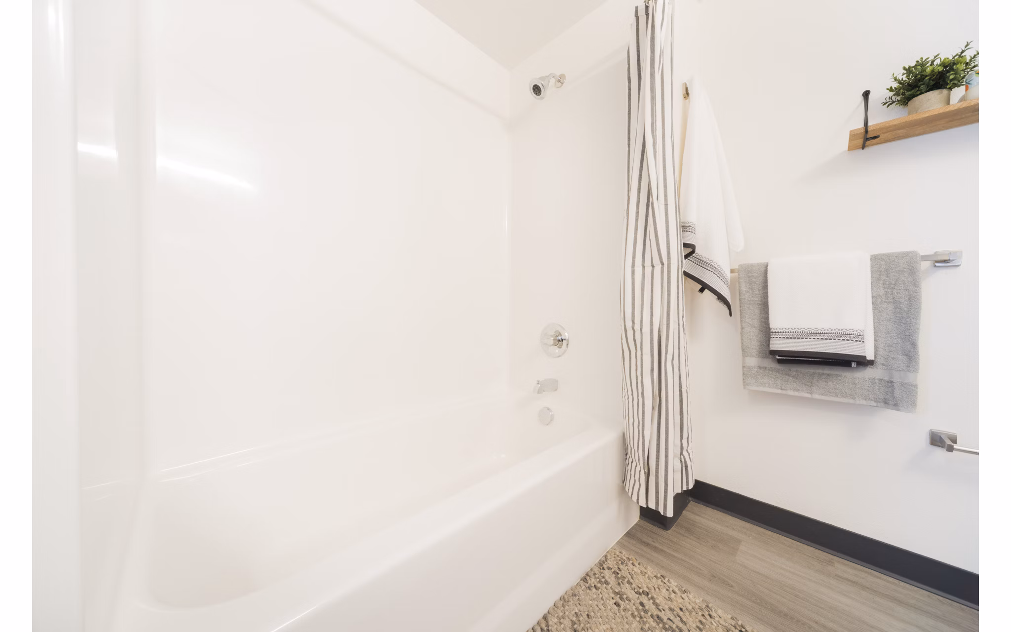 Bathroom featuring elegant marble tile and modern fixtures at The Parsonage Apartments
