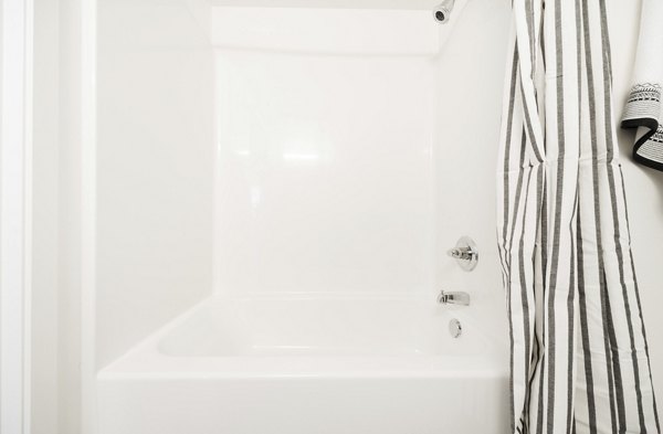 Luxurious bathroom with marble accents and modern fixtures at The Parsonage Apartments