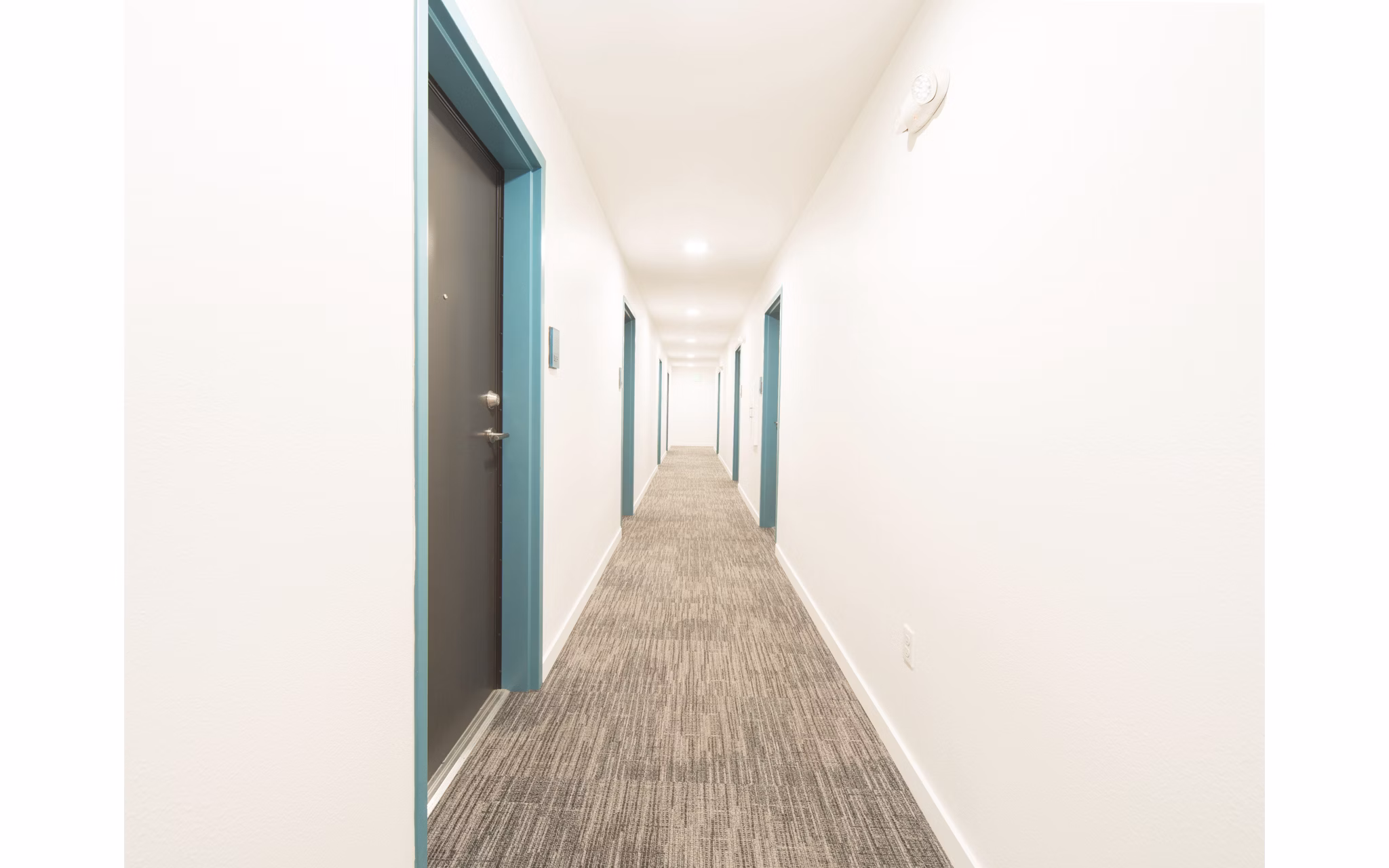Hallway featuring elegant lighting and modern design in The Parsonage Apartments