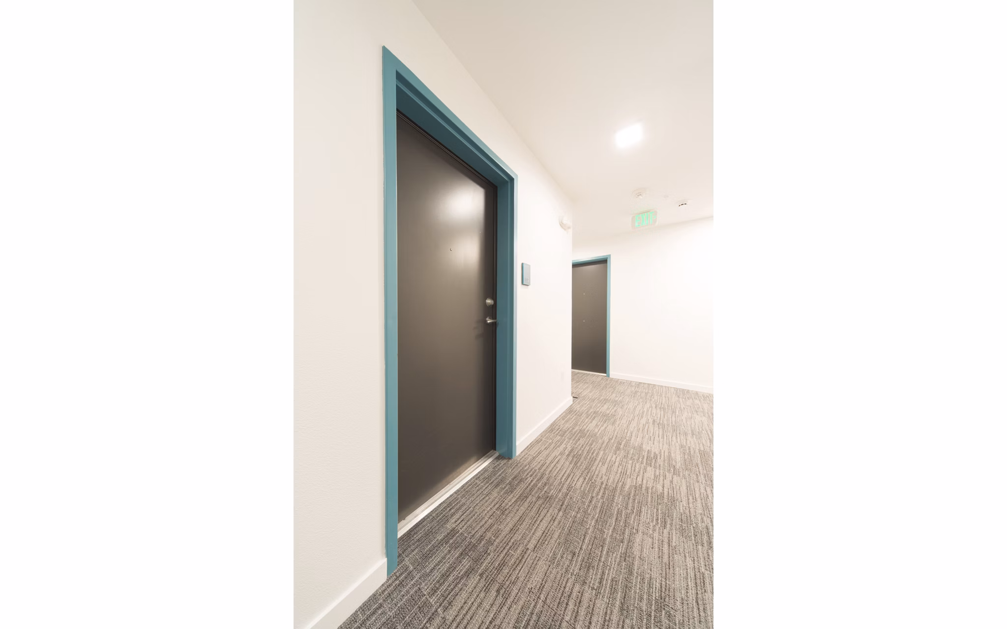 Hallway featuring contemporary design and elegant lighting at The Parsonage Apartments
