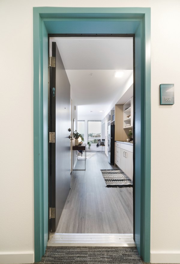 Modern hallway with stylish lighting and artwork at The Parsonage Apartments