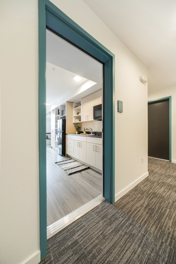 Elegant hallway featuring modern lighting and sleek flooring at The Parsonage Apartments