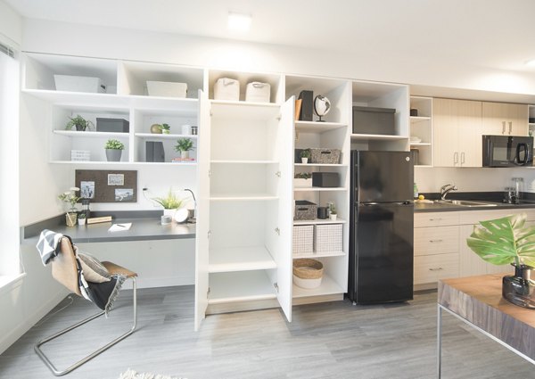 Modern kitchen with stainless steel appliances in The Parsonage Apartments