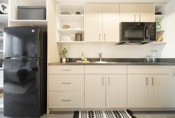 The Parsonage Apartments: Modern kitchen with stainless steel appliances and sleek countertops