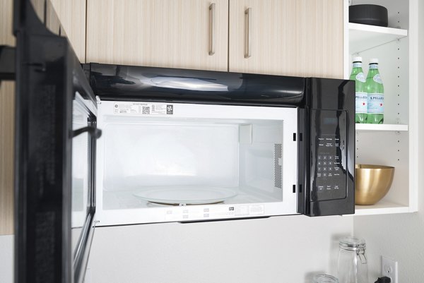 Modern kitchen with stainless steel appliances in The Parsonage Apartments