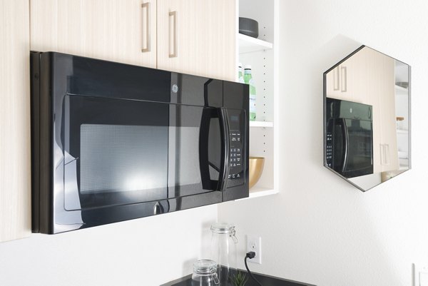 Modern kitchen with sleek stainless steel appliances in The Parsonage Apartments
