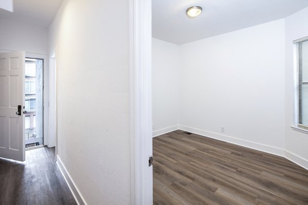 Studio entry and bedroom featuring modern decor at 1000 Chestnut Apartments, highlighting luxury living in the heart of the city