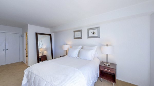 Bedroom with modern decor at 1000 Chestnut Apartments, a Greystar luxury community