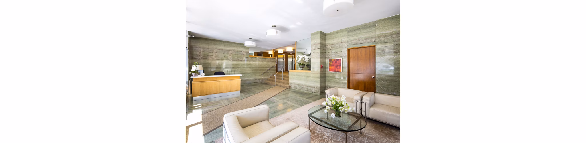 Stylish clubhouse lobby with modern seating and decor at 1000 Chestnut Apartments