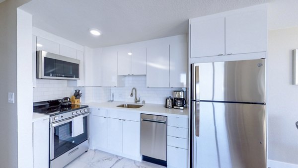 Modern kitchen with stainless steel appliances at 1000 Chestnut Apartments in San Francisco