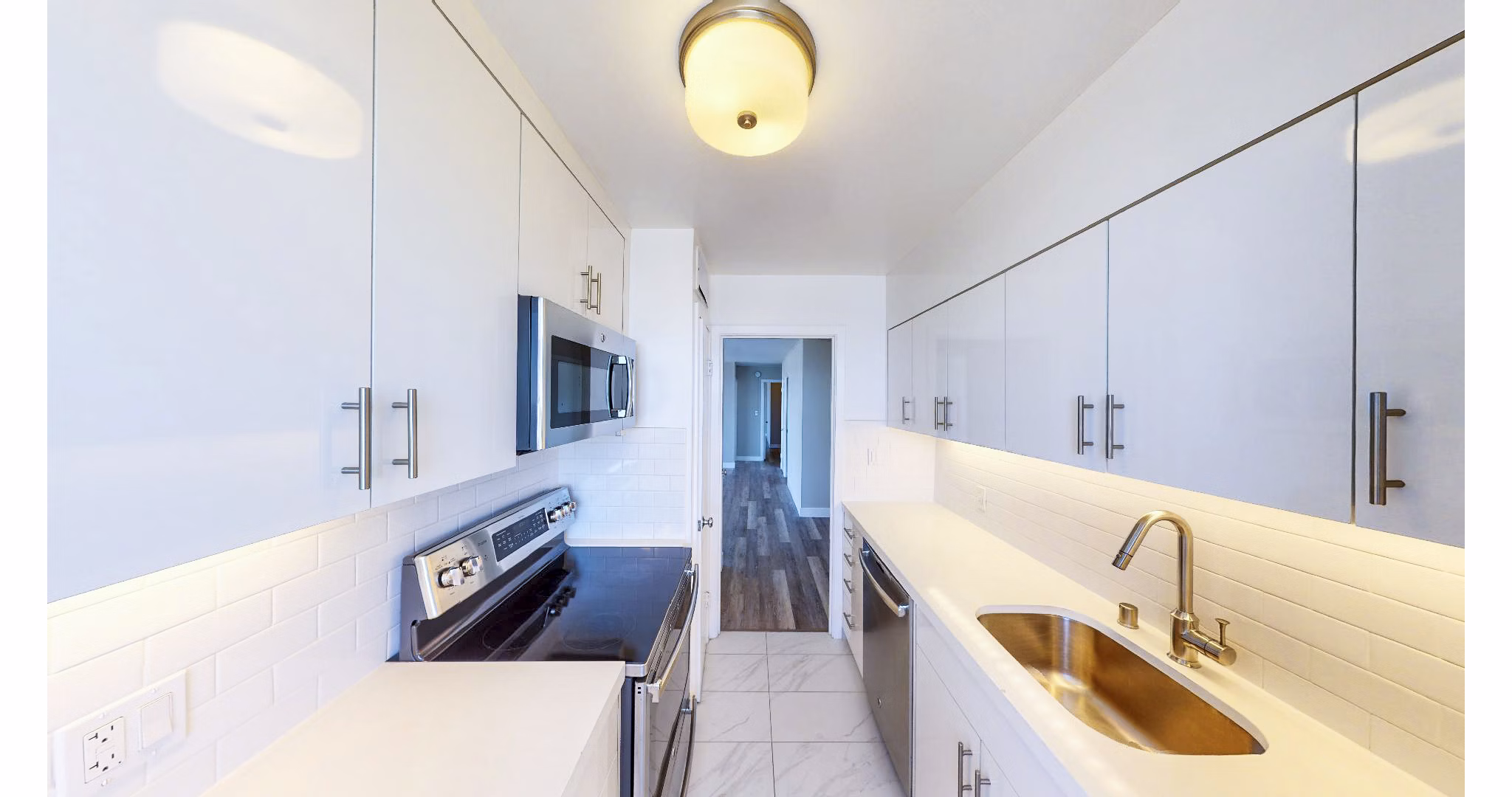 Modern kitchen featuring stainless steel appliances in 1000 Chestnut Apartments