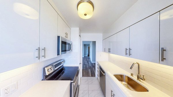 Modern kitchen featuring stainless steel appliances in 1000 Chestnut Apartments