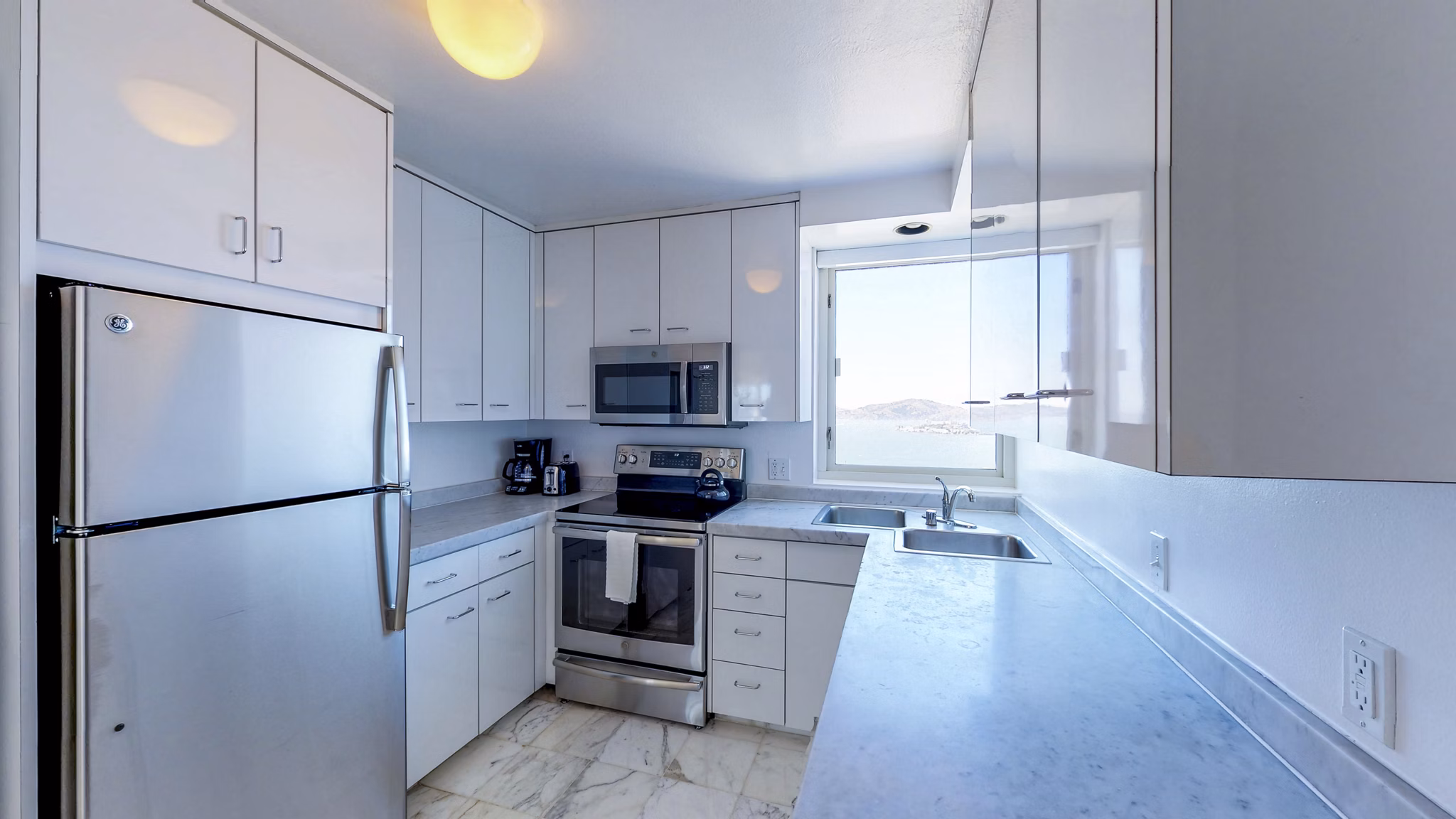 Modern kitchen featuring stainless steel appliances at 1000 Chestnut Apartments, luxury living in a vibrant community