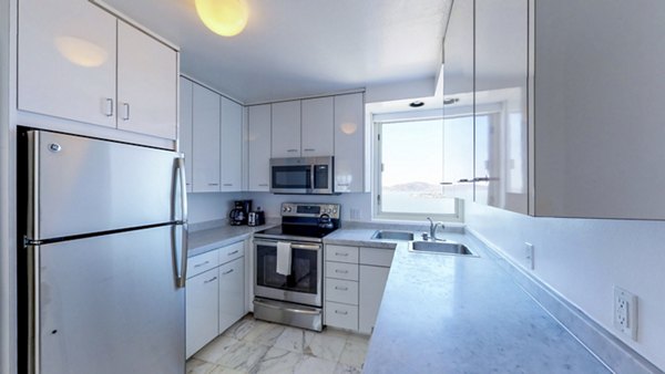 Modern kitchen featuring stainless steel appliances at 1000 Chestnut Apartments, luxury living in a vibrant community