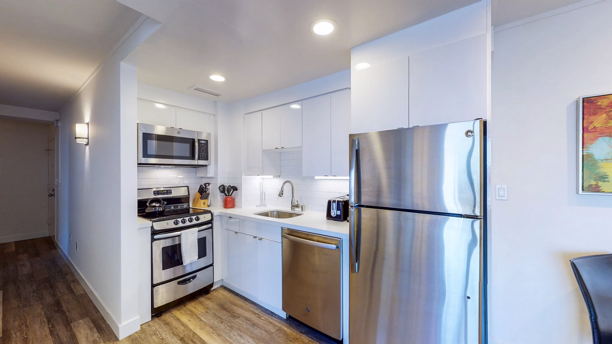 Kitchen with modern appliances and granite countertops at 1000 Chestnut Apartments