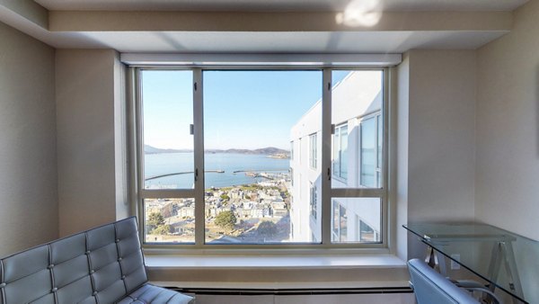 Stylish living room with modern decor and city views at 1000 Chestnut Apartments