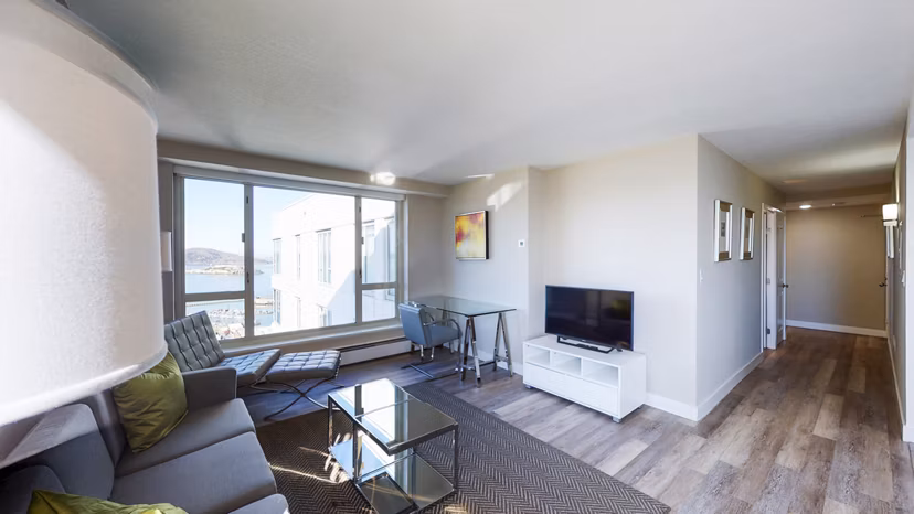 Cozy living room with modern furnishings at 1000 Chestnut Apartments, offering luxury living spaces in a prime location