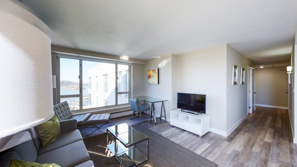 Cozy living room with modern furnishings at 1000 Chestnut Apartments, offering luxury living spaces in a prime location